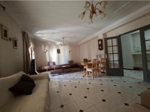 a living room with a couch and a table at Appart Hana in Bab Ezzouar