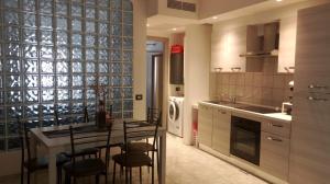 a kitchen with a table and some chairs in a room at Almes' home in Bosisio Parini