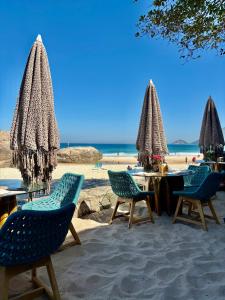 a group of chairs and tables on the beach at Pontal Beach Loft I in Rio de Janeiro