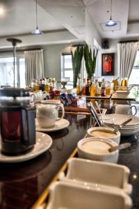 a kitchen with plates and dishes on a counter at Monte Vidéo Guesthouse in Wellington