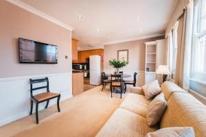 a living room with a couch and a table at No1 The Mansions By Mansley in London