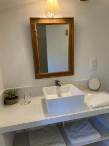 a bathroom with a white sink and a mirror at Perseïdes in Saignon +7 photos