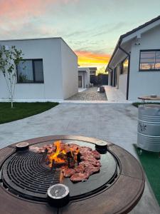 a fire pit in the backyard of a house at Poiana Events - Vilă privată cu piscină aproape de Mamaia și Constanța in Poiana