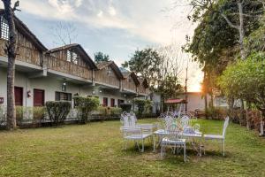 a group of tables and chairs in a yard at The Ashoka Tiger in Dhikala Zone