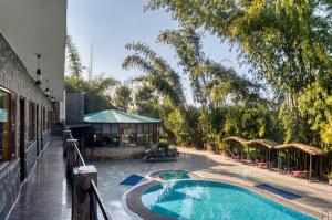a view of a swimming pool at a resort at The Ashoka Tiger in Dhikala Zone