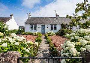 a house with a garden in front of it at Lynn Cottage in East Linton