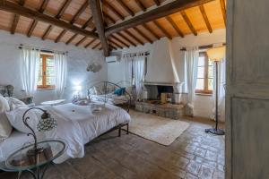 a bedroom with a large bed and a fireplace at Agriturismo Quarantallina in Buonconvento +204 photos