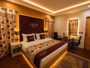 a hotel room with a large bed and a desk at Hotel Gulsar pahalgam in Pahalgām