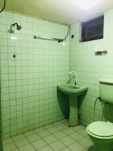 a bathroom with a toilet and a sink at Sapphire Homestay in Palle Deltota