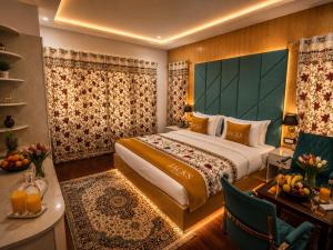 a hotel room with a bed and a table and chairs at Hotel Gulsar pahalgam in Pahalgām