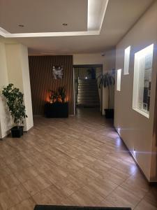 an empty lobby with potted plants in a building at Penzión ORION in Prievidza