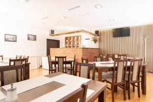 a dining room with wooden tables and chairs at Penzión ORION in Prievidza