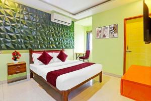 a bedroom with a bed and a desk and a television at Starlighthotels near L&T DLF MIOT Chennai Trade Center Manapakkam in Chennai