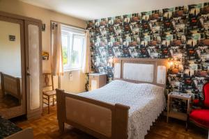 a bedroom with a bed and a patterned wall at Chambres d'hôtes à Bavent in Bavent