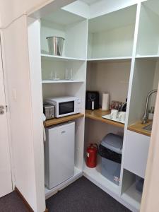 a kitchen with a refrigerator and a microwave at Dee-One's at Napier in Kenridge