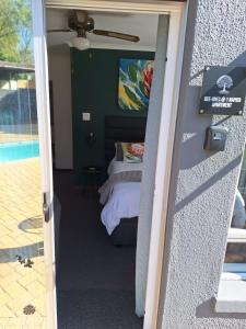 a bedroom with a bed and a view out a door at Dee-One's at Napier in Kenridge