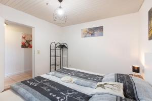 a bedroom with a bed in a white room at Schwarzwaldglück in St. Blasien
