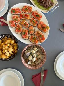 a table with plates of food and bowls of food at Nilamane in Asilah