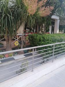a fence in front of a garden with flowers at Andros Residence in Limassol