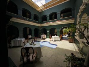 a room with tables and chairs in a building at Ébano Hotel Boutique in Oaxaca City