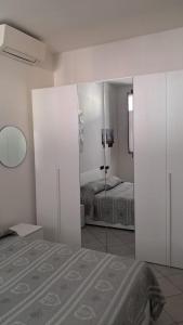 a bedroom with a reflection of a bed in a mirror at 95 by Le Suite in Lugo +2 photos