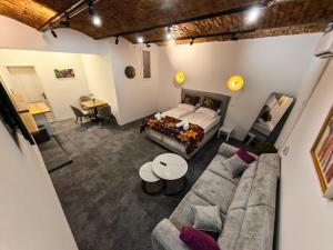 a living room with a bed and a couch at Apartments Guinness in Sarajevo