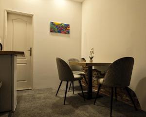 a dining room with a table and two chairs at Apartments Guinness in Sarajevo