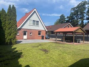 a house with a gazebo in a yard at Hotel Friesenhof in Westoverledingen
