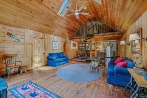a living room with blue couches and a wooden ceiling at Seventh Heaven - Hot Tub, Pet Friendly, Grill, Wifi, Deck, Covered Porch, Family Friendly, Kid's Loft, King Bed in Great Cacapon