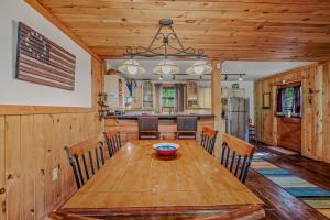 a dining room with a wooden table and chairs at Seventh Heaven - Hot Tub, Pet Friendly, Grill, Wifi, Deck, Covered Porch, Family Friendly, Kid's Loft, King Bed in Great Cacapon +32 photos