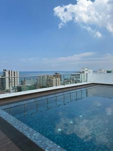 a swimming pool on the roof of a building at Bay Nest in Wellawatta