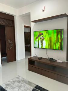 a living room with a flat screen tv on a wall at Bay Nest in Wellawatta