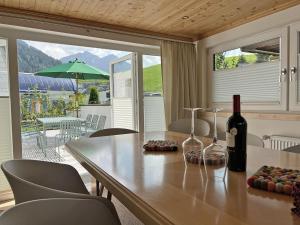 a table with a bottle of wine and two glasses at Die Talstation in Riezlern