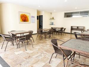 a dining room with tables and chairs at Premium Apartment with Ocean View in Santiago +7 photos