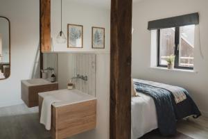 a bathroom with a sink and a bed and a sink at Kennet in Marlborough