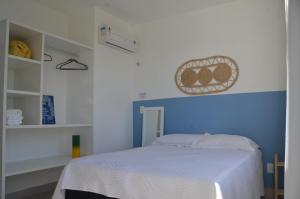 a bedroom with a bed with a blue and white wall at #204 Corais de Búzios - Apartamento à beira-mar na enseada de Búzios in Nísia Floresta +11 photos