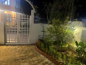 a gate to a house at night with plants at Minh's homestay in Long Bình +2 photos