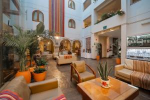 a lobby with couches and chairs in a building at San Agustin El Dorado in Cusco