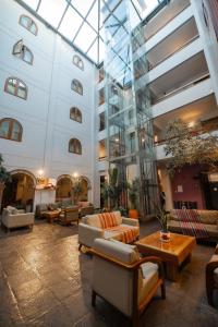 a lobby with couches and tables in a building at San Agustin El Dorado in Cusco