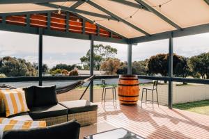 patio with a hammock and a view of theabwepterangeringktop at Seascape Cottage on Kangaroo Island in Baudin Beach +57 photos
