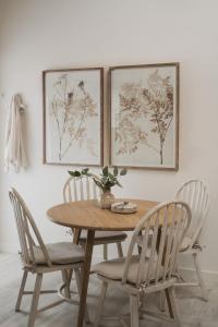 a dining room table with chairs and a vase on it at Ridgeway in Marlborough
