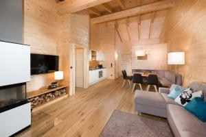 a living room with a couch and a dining room at Rittis Alpin Chalets Dachstein in Ramsau am Dachstein