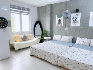 a bedroom with a bed and a couch in it at Full House Cát Bà in Cat Ba +19 photos