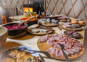 a table topped with lots of different types of food at La Yourte Un Autre Monde in Le Hohwald