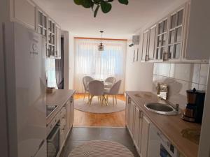 a kitchen with a sink and a table in it at Elite Suites - Vogošća in Vogošća