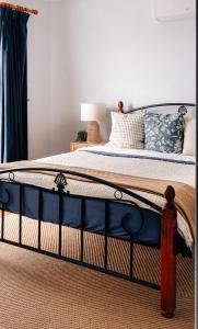 a bedroom with a bed with blue and white sheets at Seascape Cottage on Kangaroo Island in Baudin Beach