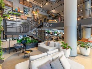 a lobby with a white couch and a staircase at ibis Sao Paulo Barra Funda in São Paulo