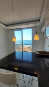 a dining room with a table and a view of the ocean at Urla Sea View House in Urla