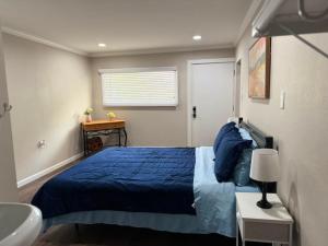 a bedroom with a blue bed and a sink at The Sandstone Suite in Cleveland