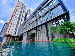 a building with a pool of water in front of it at Lucentia residence luxury suites in Kuala Lumpur